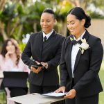 DMG Security & Company Wedding Security. Two security guards checking the wedding guest list to ensure the parties security.